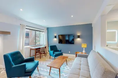 a living room with a couch and two chairs and a table at Mammoth Ski & Racquet 93K in Mammoth Lakes
