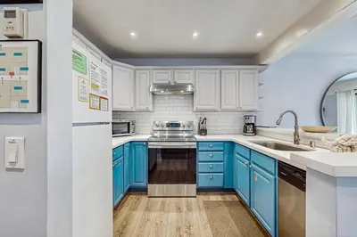 a kitchen with blue cabinets and a sink at Mammoth Ski & Racquet 93K in Mammoth Lakes