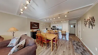 a living room with a couch and a table with chairs at Spacious 3 Bed 3 Bath Condo with Pool in Mammoth Lakes