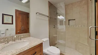 a bathroom with a shower and a toilet and a sink at Spacious 4 Bed 3 Bath Condo Great For Families! in Mammoth Lakes