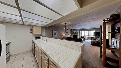 a kitchen with a counter and a living room at Fantastic 3 Bedroom Condo with Great Views in Mammoth Lakes