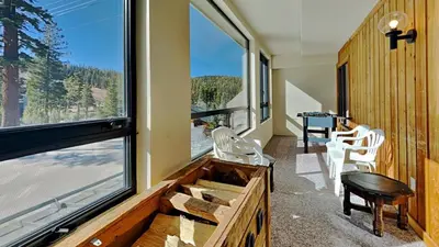a room with a large window and a table and chairs at Amazing 2 Bedroom Condo with Awesome View! in Mammoth Lakes