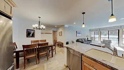 a kitchen and living room with a table and chairs at One Bedroom Condo Close To Canyon Lodge! in Mammoth Lakes