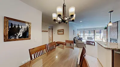 a dining room and living room with a dining table at One Bedroom Condo Close To Canyon Lodge! in Mammoth Lakes