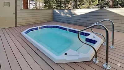 a swimming pool on the deck of a house at One Bedroom Condo Close To Canyon Lodge! in Mammoth Lakes