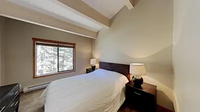 a bedroom with a white bed and a window at Beautifully Remodeled 4 Bedroom Home in Mammoth Lakes
