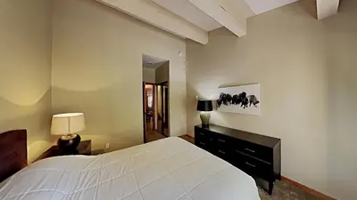 a bedroom with a large white bed and a mirror at Beautifully Remodeled 4 Bedroom Home in Mammoth Lakes