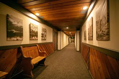 a hallway with a bench and pictures on the walls at Beautiful Remodeled One Bedroom Condo! in Mammoth Lakes