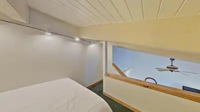 a small bedroom with a bed and a window at Cozy One Bedroom Condo with Loft! in Mammoth Lakes