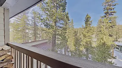 a balcony of a house with trees in the background at Cozy One Bedroom Condo with Loft! in Mammoth Lakes