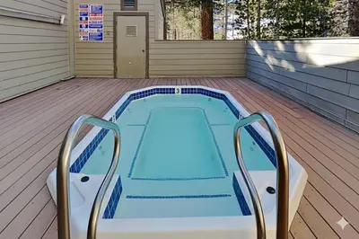 a swimming pool on a deck with a house at Spacious One Bedroom Condo with Full Kitchen! in Mammoth Lakes