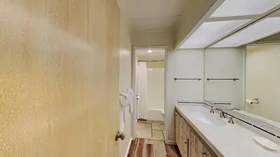 a bathroom with two sinks and a large mirror at Updated 2 Bdrm Condo with Shared Hot Tub in Mammoth Lakes