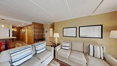 a living room with a couch and a table at Updated 2 Bdrm Condo with Shared Hot Tub in Mammoth Lakes