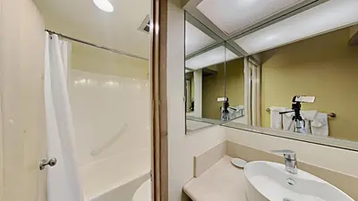 a bathroom with a sink and a mirror at Updated 2 Bdrm Condo with Shared Hot Tub in Mammoth Lakes