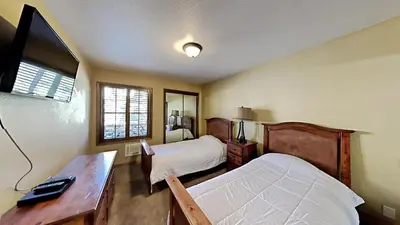 a hotel room with two beds and a desk and a desk at Remodeled 2 Bedroom Condo withFull Kitchen! in Mammoth Lakes