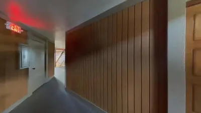 a hallway with a wood paneled wall in a building at Remodeled 2 Bedroom Condo withFull Kitchen! in Mammoth Lakes