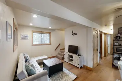 a living room with a couch and a tv at Pine Cone Cabin in Soda Springs