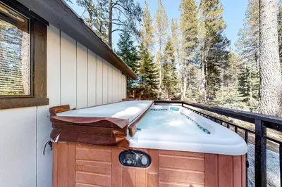 a hot tub on the deck of a house at Pine Cone Cabin in Soda Springs