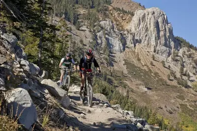 two people riding bikes on a mountain trail at Chateau Sans Nom 29 in Mammoth Lakes