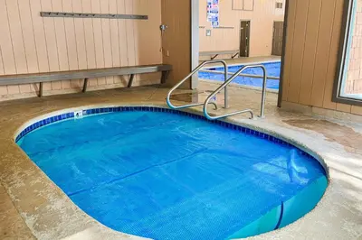 a large swimming pool in a building with blue water at Chateau Sans Nom 29 in Mammoth Lakes