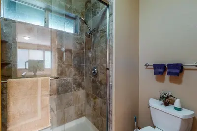 a bathroom with a shower and a toilet with a glass door at Comfortable and Convenient Truckee Condo in Truckee