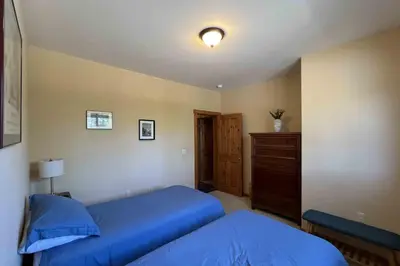 a bedroom with a blue bed and a dresser at Comfortable and Convenient Truckee Condo in Truckee