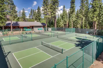 a group of tennis courts with trees in the background at Cozy Condo in Ski Trails in Truckee