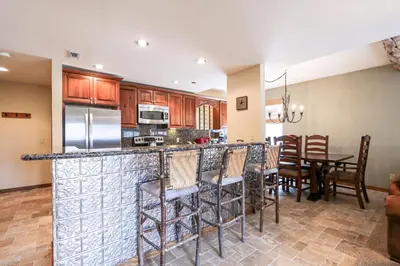 a kitchen and dining room with a bar and chairs at Silver Bear #22 condo in Mammoth Lakes