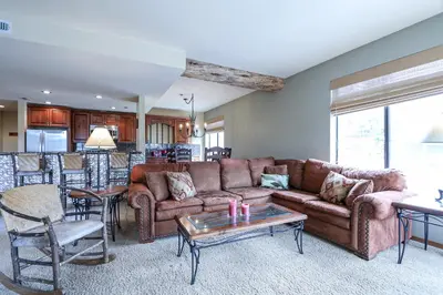 a living room with a couch and a table at Silver Bear #22 condo in Mammoth Lakes