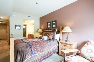 a bedroom with a large bed and a couch at Silver Bear #22 condo in Mammoth Lakes