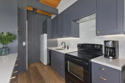 a kitchen with blue cabinets and a black stove at Villa de los Pinos 42 in Mammoth Lakes