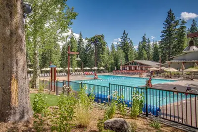 a pool at a resort with people in it at Delightful Northstar Condo in Kingswood Estates