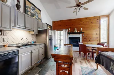 a kitchen with a sink and a table in a room at Kings Run Relaxation in Kings Beach