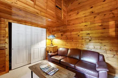 a living room with a leather couch and a door at Kings Run Relaxation in Kings Beach