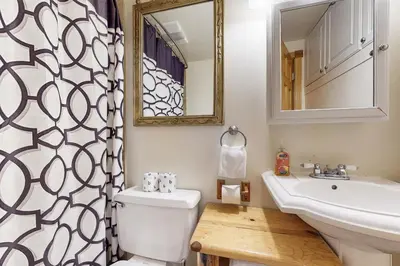 a bathroom with a sink and a toilet and a mirror at Kings Run Relaxation in Kings Beach