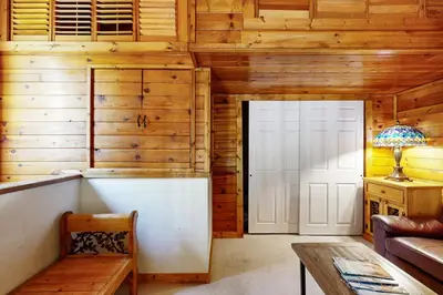 a living room with a wooden wall and a door at Kings Run Relaxation in Kings Beach