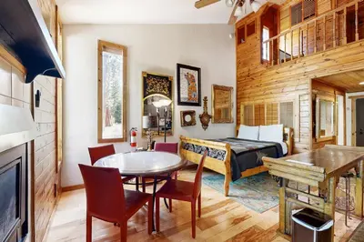 a room with a bed and a table and chairs at Kings Run Relaxation in Kings Beach