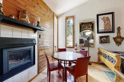 a dining room with a table and a fireplace at Kings Run Relaxation in Kings Beach