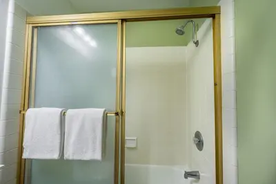 a shower with a glass door and white towels at Helios S # 5 in Mammoth Lakes