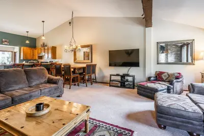 a living room with a couch and a table at Helios S # 5 in Mammoth Lakes