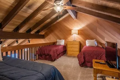 a attic room with two beds and a ceiling fan at Snowcreek #97 Phase I in Mammoth Lakes