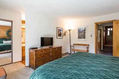 a bedroom with a bed and a television at Snowcreek #97 Phase I in Mammoth Lakes