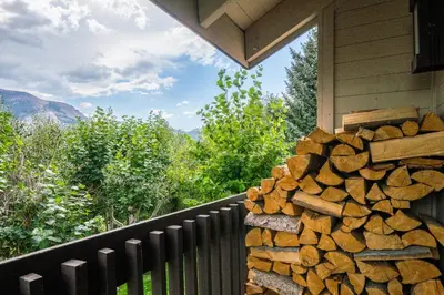 a pile of fire wood on the side of a house at Snowcreek #97 Phase I in Mammoth Lakes