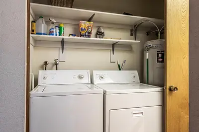 a laundry room with two washes and a refrigerator at Snowcreek #97 Phase I in Mammoth Lakes
