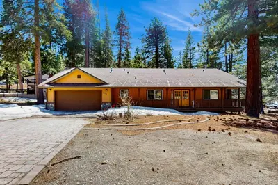 a house with a garage in the woods at Makoto in Stateline