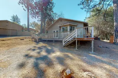a house with a large porch and a house at Holiday Chalet in Groveland