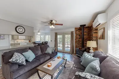 a living room with a couch and a table at Holiday Chalet in Groveland