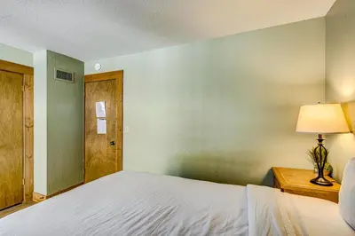 a bedroom with a bed and a table with a lamp at Enjoyable Northstar Condo in Kingswood Estates