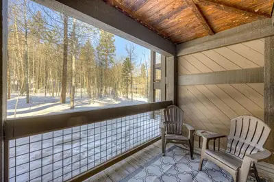 a screened in porch with two chairs and a window at Enjoyable Northstar Condo in Kingswood Estates