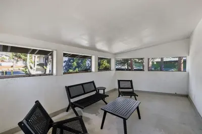 three chairs and a table in a room with windows at South Lake Chalet by Heavenly in South Lake Tahoe